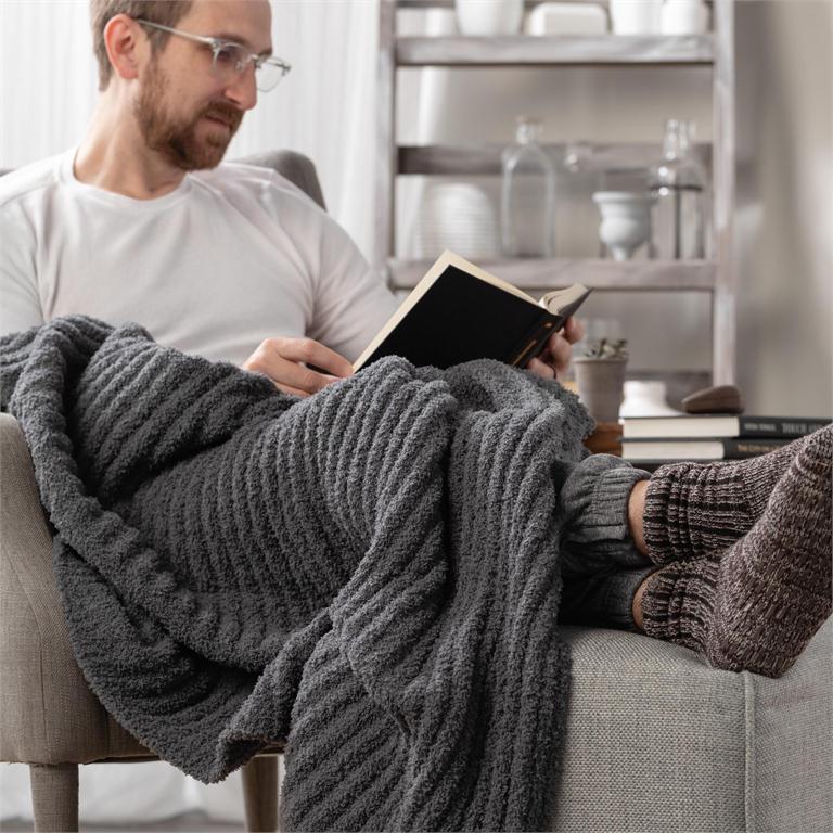 Man with gray ribbed blanket