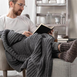 Man with gray ribbed blanket