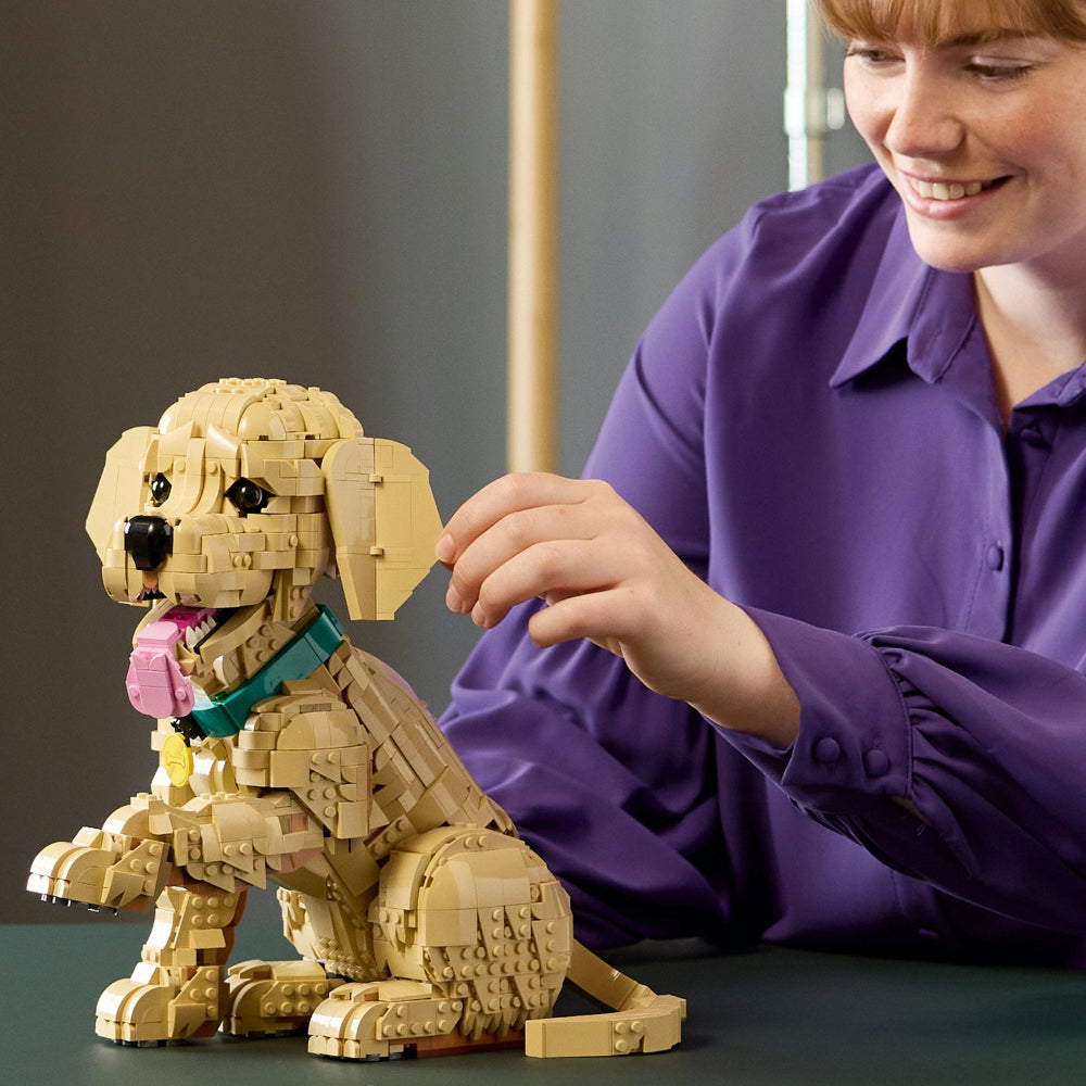 Woman playing with Lego Golden Retriever Puppy