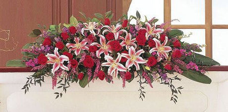 Amethyst and Ruby Casket Spray of red and pink flowers for funeral