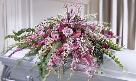 Casket spray of assorted lavender flowers for funeral