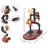 Steampunk-style industrial table lamp with black and brass pipe components, red valve details, and a round wooden base, shown on a white background with dimension lines and inset detail circles.